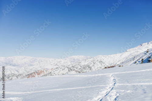 Picturesque Tien Shan mountains in Uzbekistan, partially covered with snow, winter clear Sunny day in the mountains