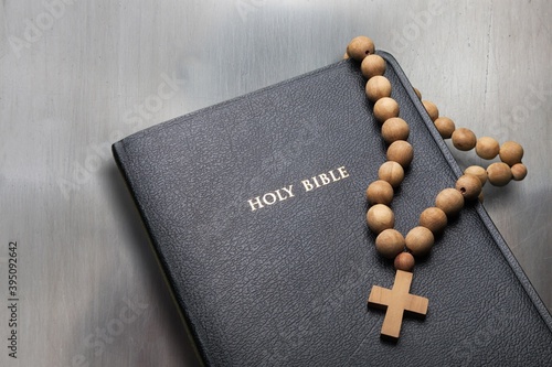 The Holy black bible on a wooden table.