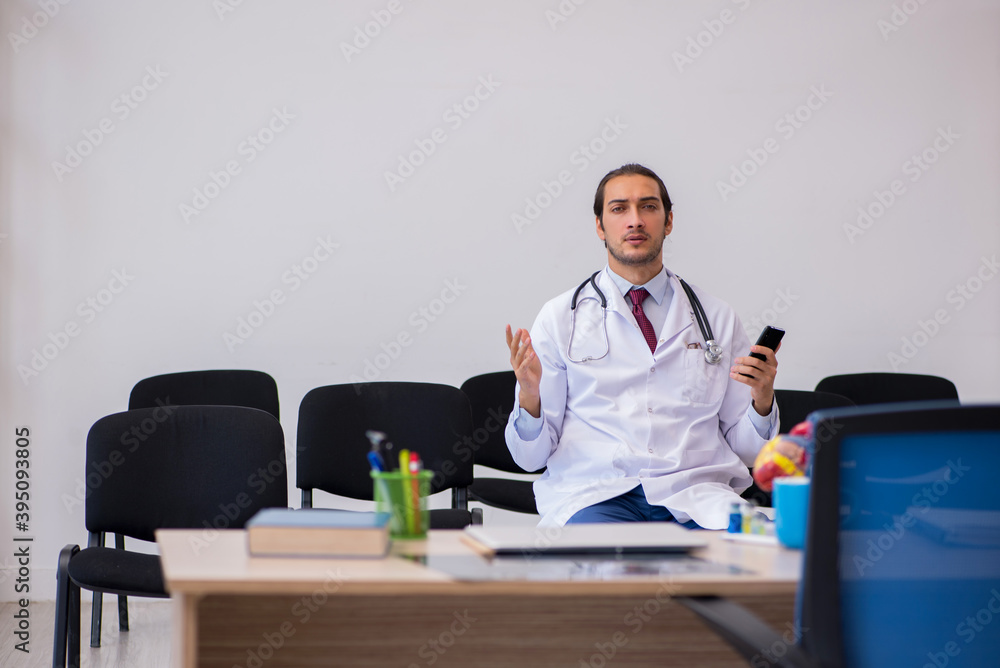 Young male doctor giving seminar in the classroom Young male doctor giving seminar in the classroom
