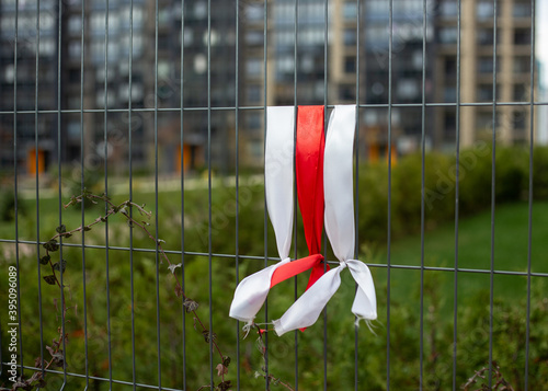 White-red-white ribbons on the fence. White-red-white flag.
