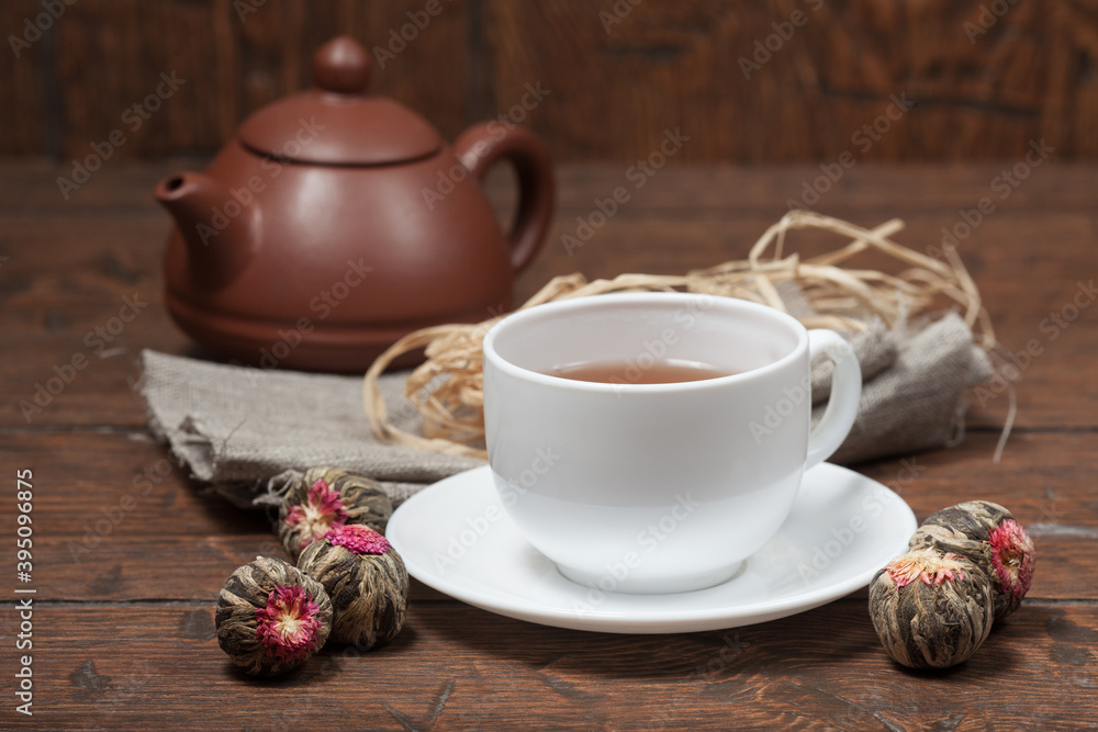 Clay Chinese teapot pot and cup of tea with Flower Chinese tea on old wooden table Clay Chinese teapot pot and cup of tea with Flower Chinese tea on old wooden table