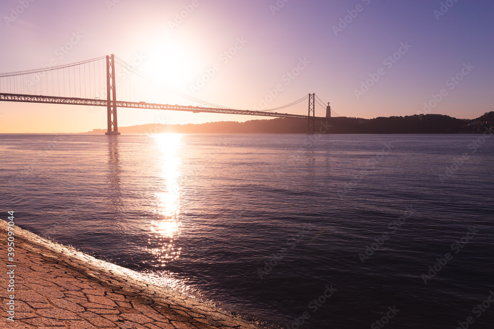 Ponte 25 de Abril Lisboa Lisbon Portugal bridge and Sanctuary of Christ the King, Santuário de Cristo Rei in the morning sunrise over Tagus river Ponte 25 de Abril Lisboa Lisbon Portugal bridge and Sanctuary of Christ the King, Santuário de Cristo Rei in the morning sunrise over Tagus river