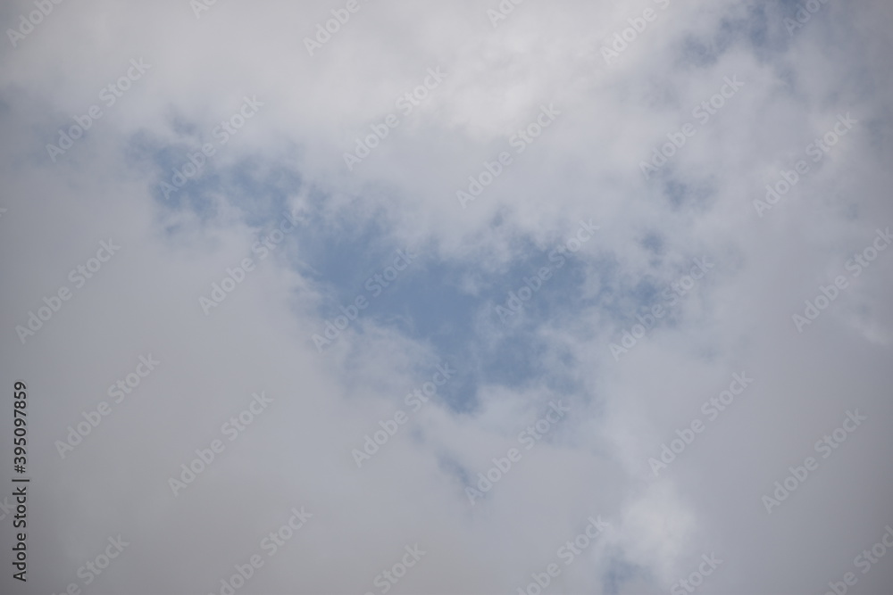 Blue sky with puffy white clouds.