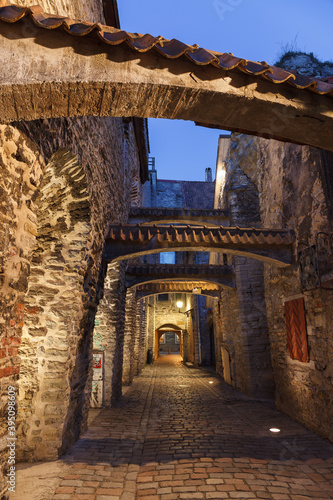 Medieval street in old town, Katarina Passage, Tallinn, Estonia. Illuminated at evening