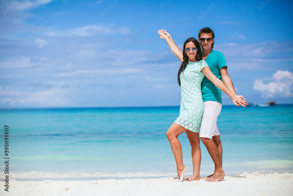 Young couple on white beach during summer vacation. Young couple on white beach during summer vacation.