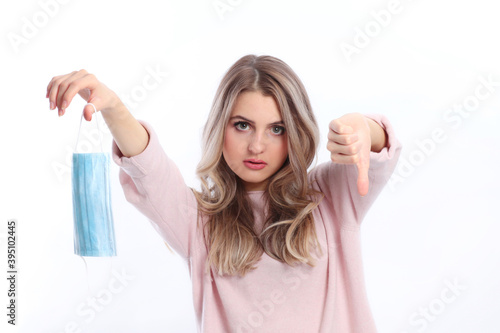 Woman holds up face mask