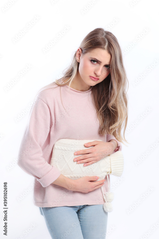 Woman with hot bottle on her belly isolated Woman with hot bottle on her belly isolated