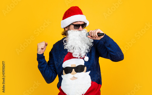 cheerful santa man hipster sing christmas music songs. preparation and celebration. funny party time. happy winter holidays. new year mood. christmas shopping. sales and discounts. buy xmas gifts