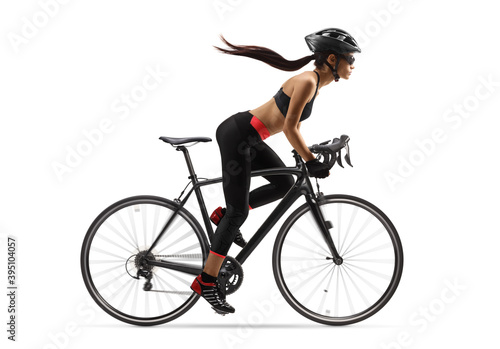 Fototapeta Naklejka Na Ścianę i Meble -  Female cyclist with a long ponytail waving, riding a road bicycle