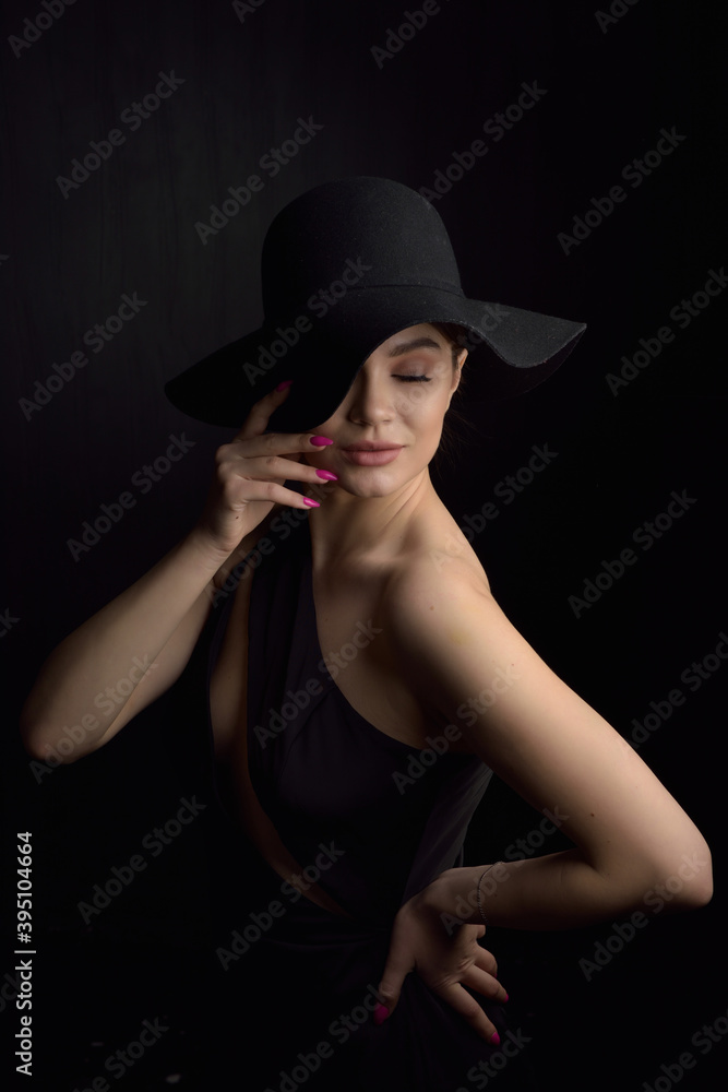 Beautiful woman in hat. Retro fashion. Dark Background. Beautiful woman in hat. Retro fashion. Dark Background.