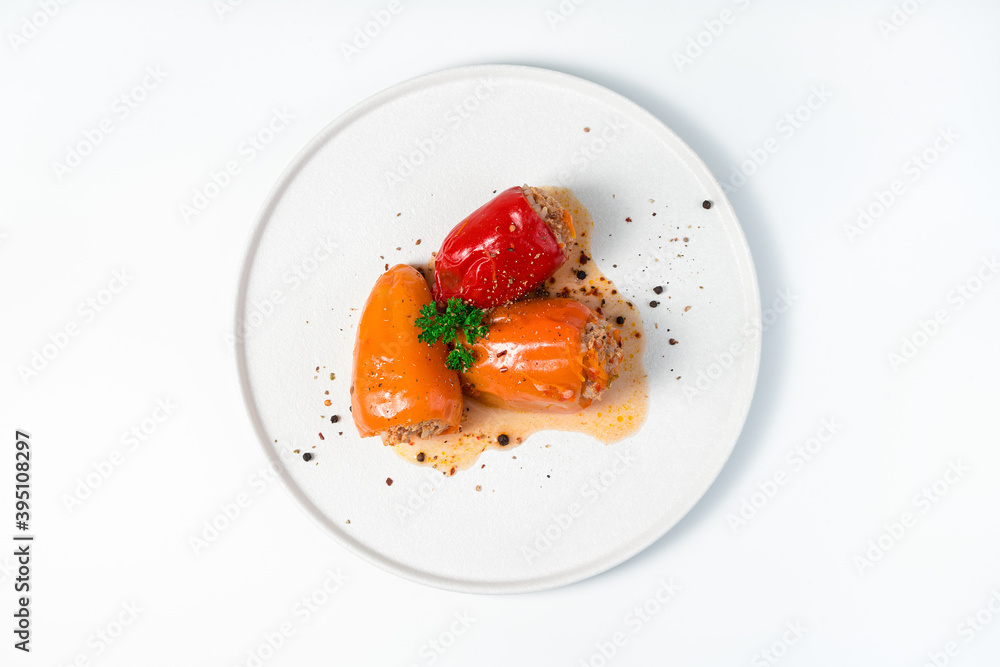 Three bell peppers with rice and minced meat on a light background. Top view, close-up. The concept of cooking. Three bell peppers with rice and minced meat on a light background. Top view, close-up. The concept of cooking.