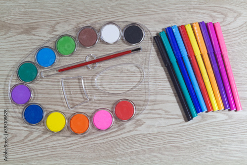 Multicolored felt-tip pencils and paint palette for children