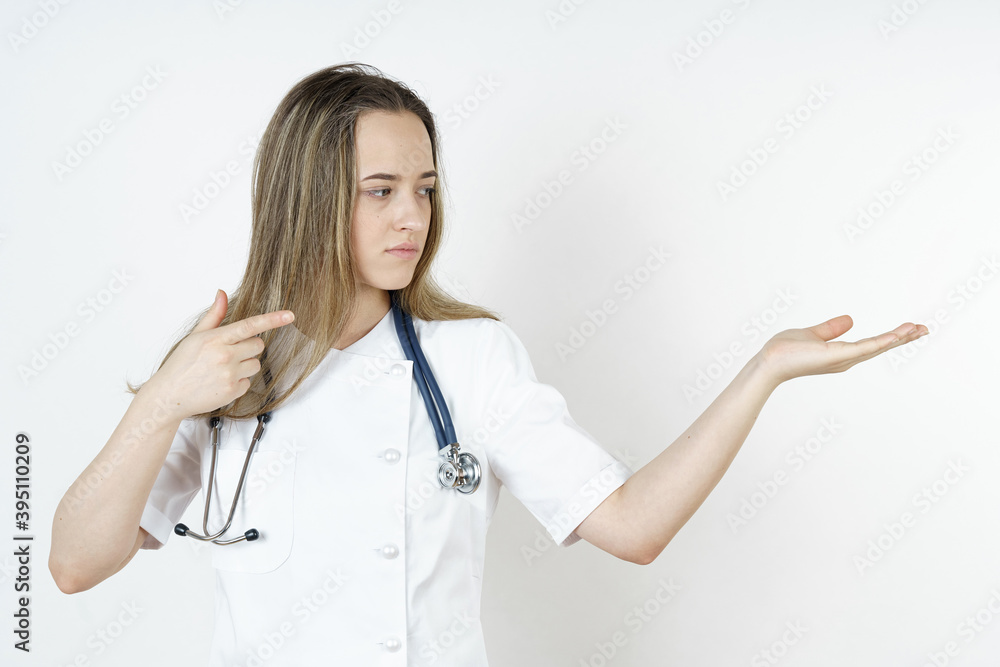 Medicine and health concept. The doctor points his hands to the side and looks there. Medicine and health concept. The doctor points his hands to the side and looks there.