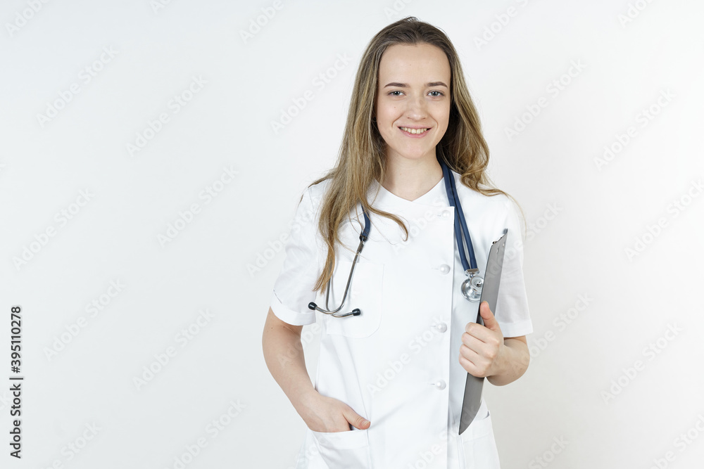 Medicine and health concept. A portrait of a doctor who stands with a tablet in his hands and looks at the camera. Medicine and health concept. A portrait of a doctor who stands with a tablet in his hands and looks at the camera.