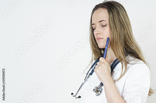 Medicine and health concept. The doctor read it thoughtfully, holding a pen to his face.
