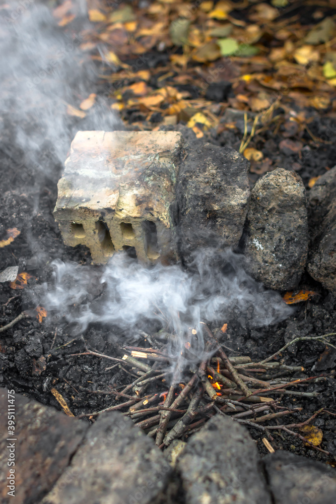 How to make a fire. Burning brushwood. Small branches for a fire. Smoke
