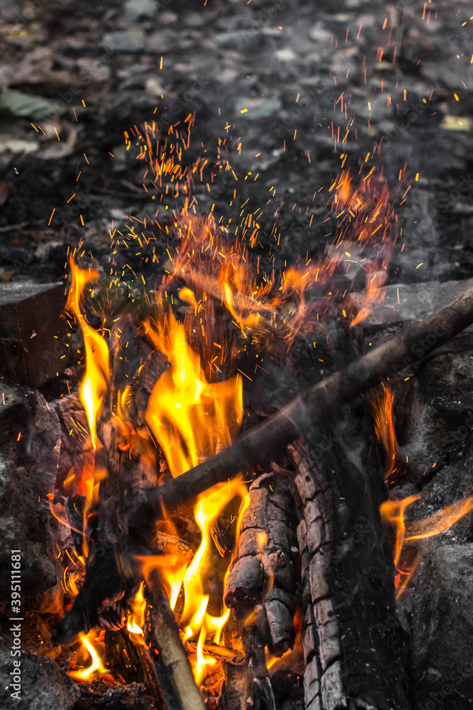 Bright flames. Fire sparks. Burning firewood. Crackling logs on fire. Smouldering coals. Christmas background. The heat and warmth of an open fire. Risk of fire. Dangerous behavior with fire. Bright flames. Fire sparks. Burning firewood. Crackling logs on fire. Smouldering coals. Christmas background. The heat and warmth of an open fire. Risk of fire. Dangerous behavior with fire.