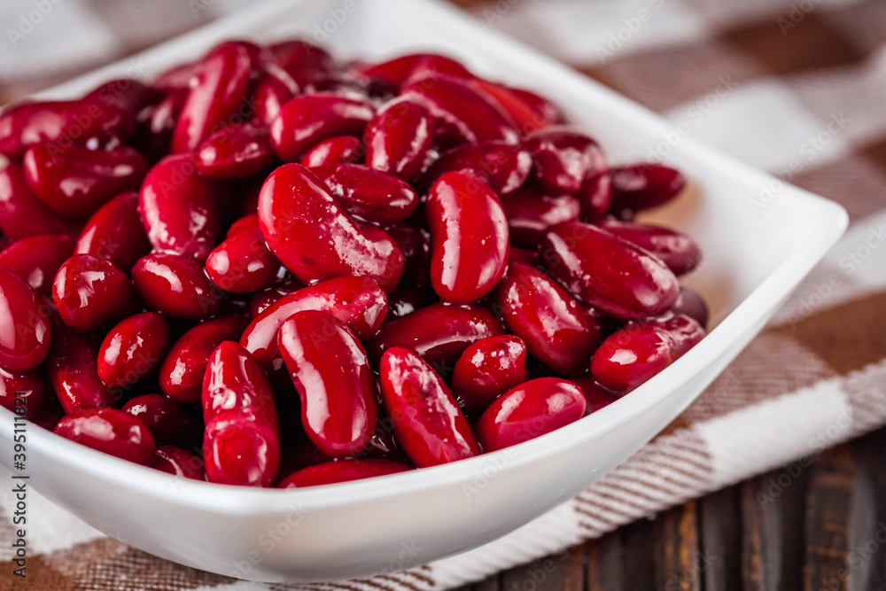 canned red kidney beans on a dark wooden rustic background canned red kidney beans on a dark wooden rustic background
