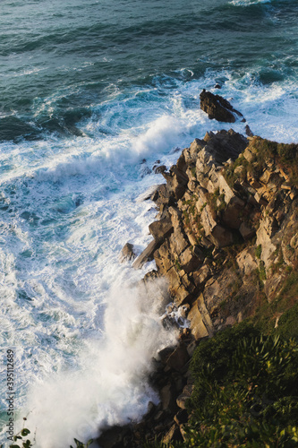 Waves breaking in the coastal cliffs during sunset