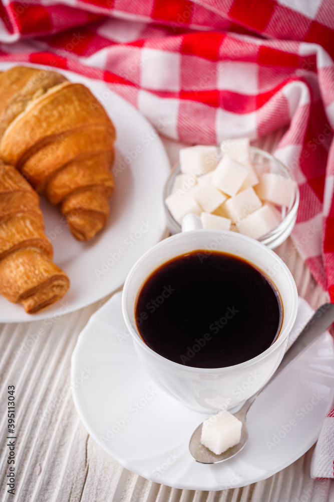 delicious fresh croissant and cup of coffee on a white wooden rustic background delicious fresh croissant and cup of coffee on a white wooden rustic background