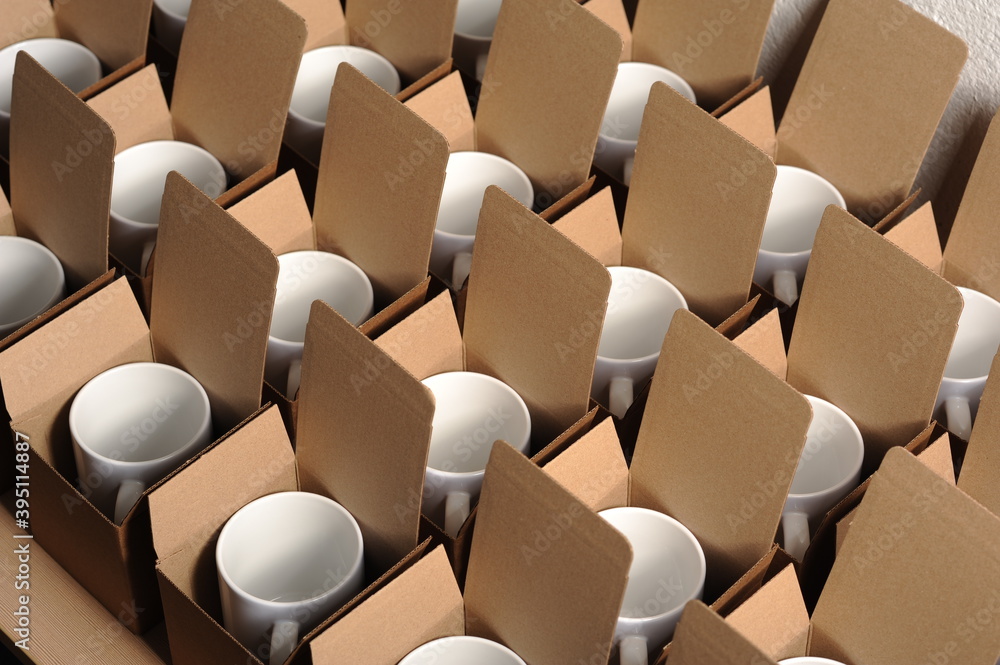 Fototapeta premium white mugs in craft cardboard boxes