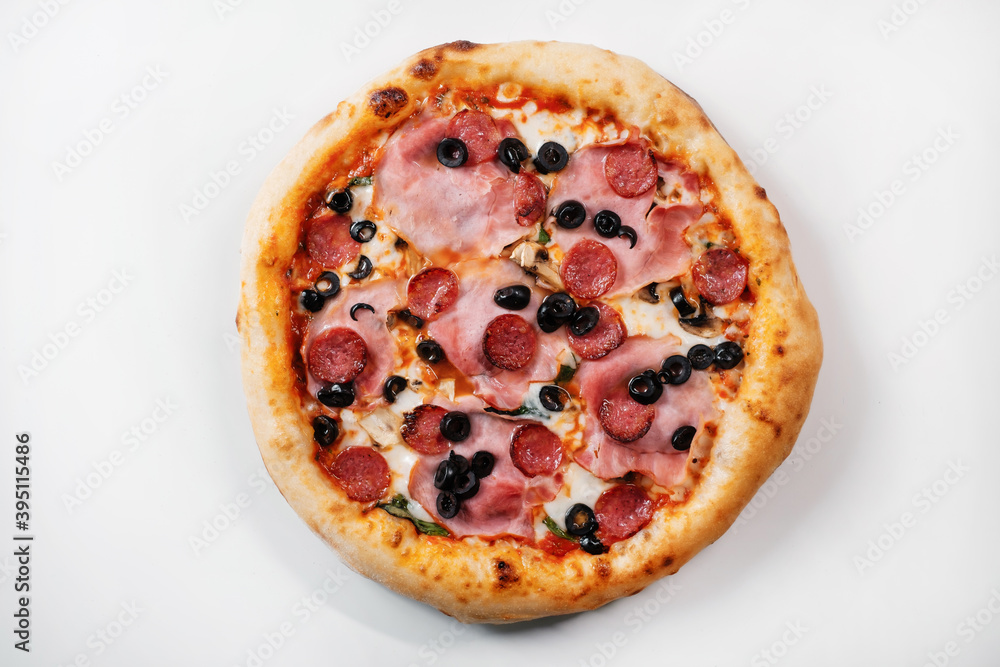 Italian pizza with salami, ham, olives and mushrooms. Italian fast food delivery. Italian pizza with salami, ham, olives and mushrooms. Italian fast food delivery.