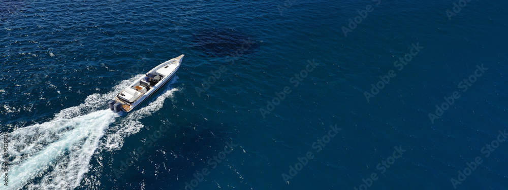 Aerial drone photo of luxury inflatable speed boat cruising in deep blue  Aegean sea, Mykonos island, Cyclades, Greece Photos | Adobe Stock