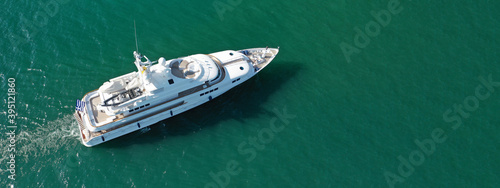 Aerial drone top down ultra wide panoramic photo of luxury yacht anchored in Mediterranean port © aerial-drone