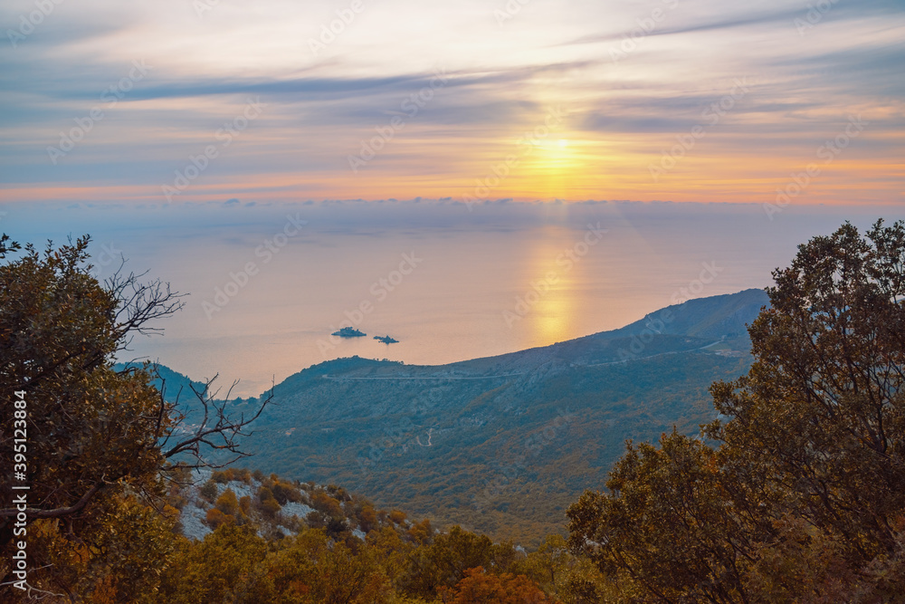 Autumn sunset. Sun, sea and mountains. Montenegro, coast of Adriatic Sea near town of Budva