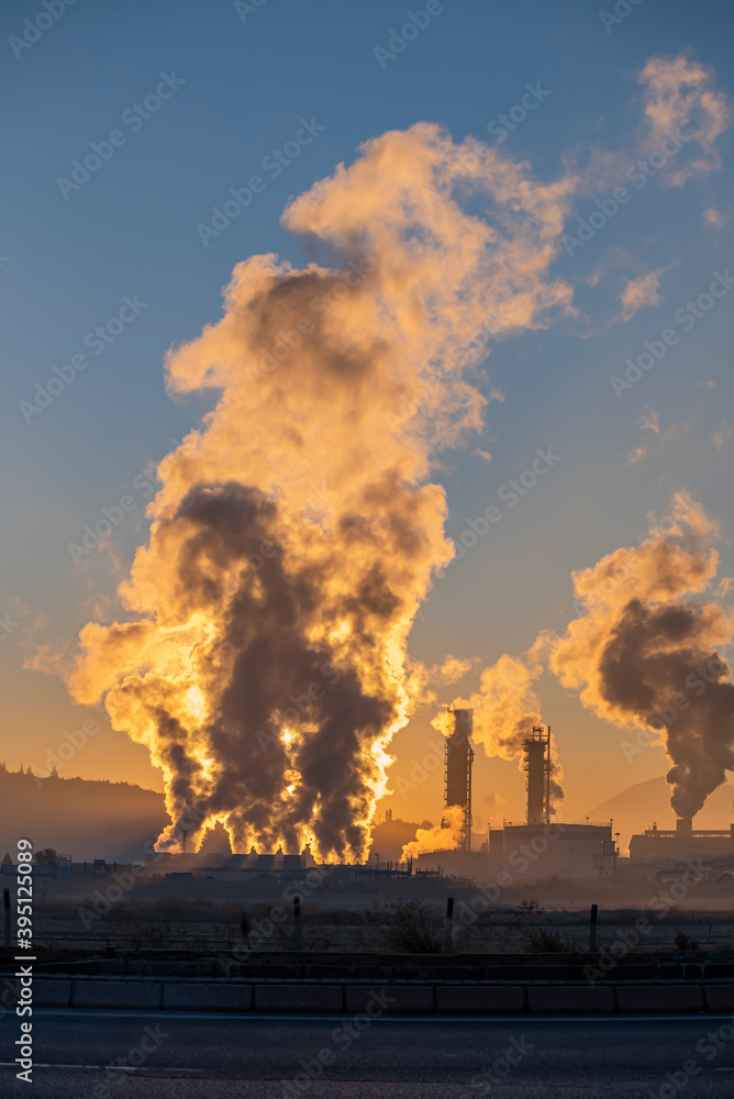 Factory smoke chimney piping smoke or steam into the air pollution