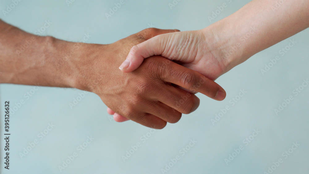 White and black hand connect. Anti-racism. Stop racism, all people are equal. Friendship of Peoples. Black lives matter White and black hand connect. Anti-racism. Stop racism, all people are equal. Friendship of Peoples. Black lives matter