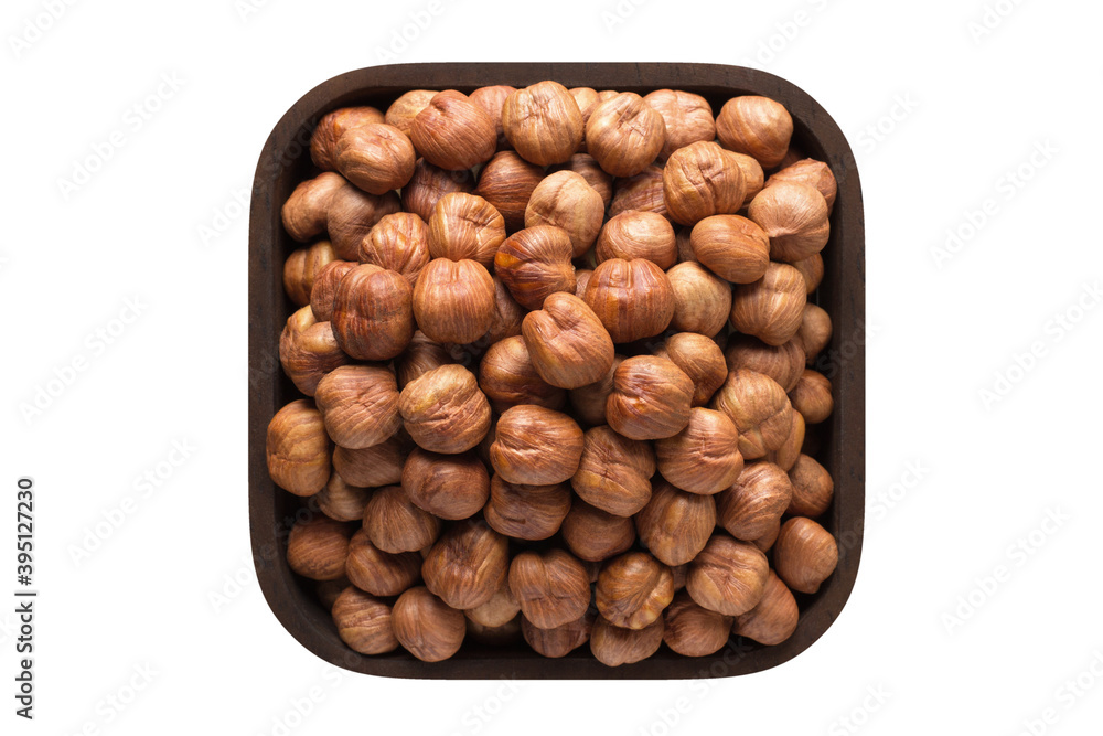 hazelnut peeled raw in square bowl isolated on white background. organic food, top view.