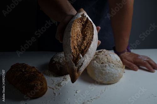 Bake man holding a big bread in his hand