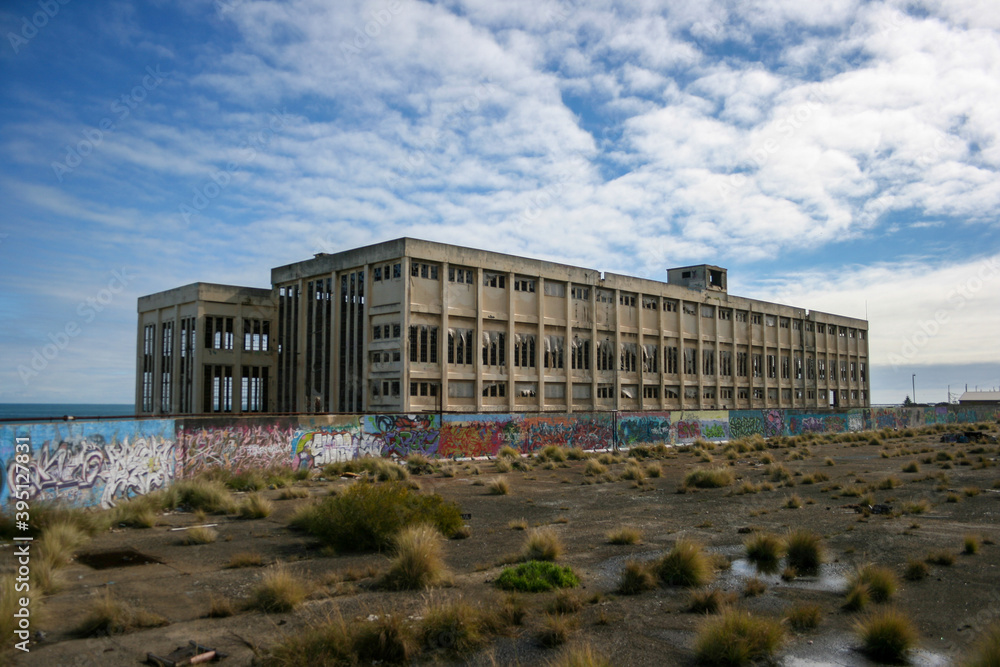 Old Power Station in Fremantle with graffiti on sunny day with blue sky and some clouds, next to the beach, lost places, Perth, Western Australia