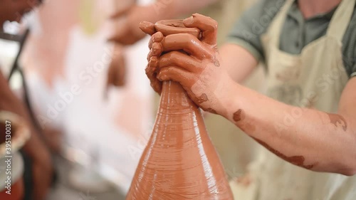 Pottery girl enjoying pottery art and production process. Hand work. Close-up. photo