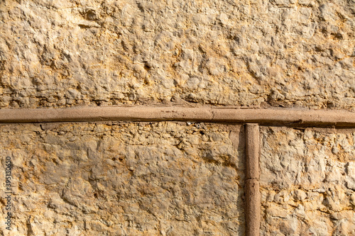 Handcarved sandstone wall closeup detail.