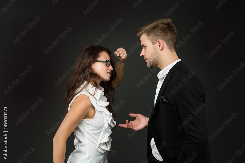 Angry professional woman clench fist at male coworker in formalwear dark background, fighting