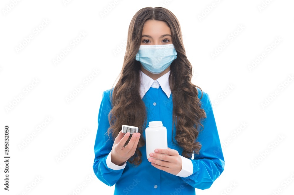girl hold vitamins or medicine drug pills from fever wearing protective medical mask isolated on white, corona virus girl hold vitamins or medicine drug pills from fever wearing protective medical mask isolated on white, corona virus