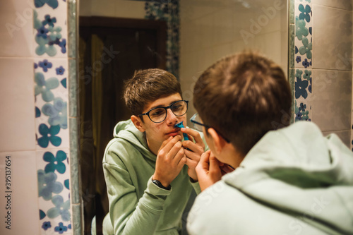 young teenager shaving in the bathroom