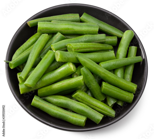 green beans in a black plate isolated on white background. Clipping path and full depth of field. Top view