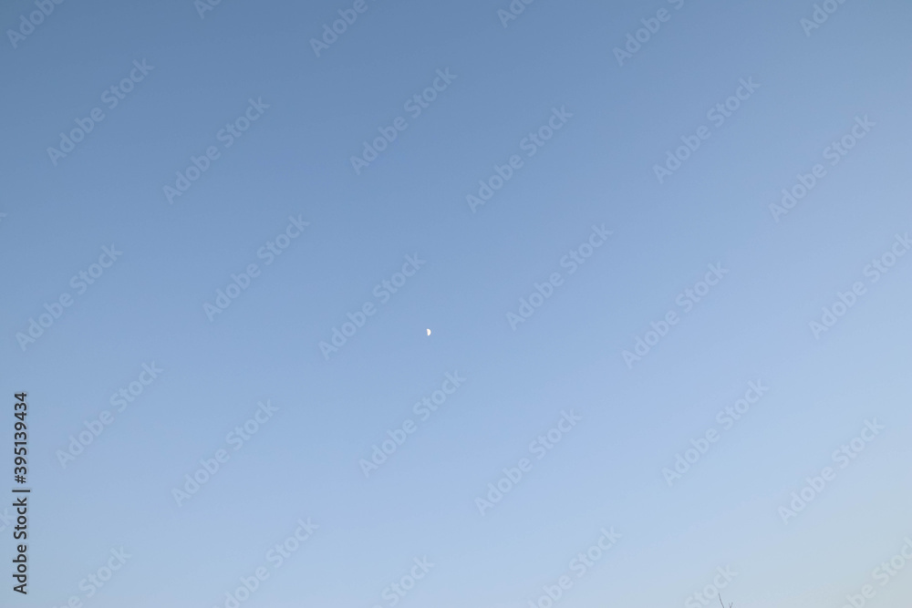 Blue light sky and the half moon. Blue light sky and the half moon.