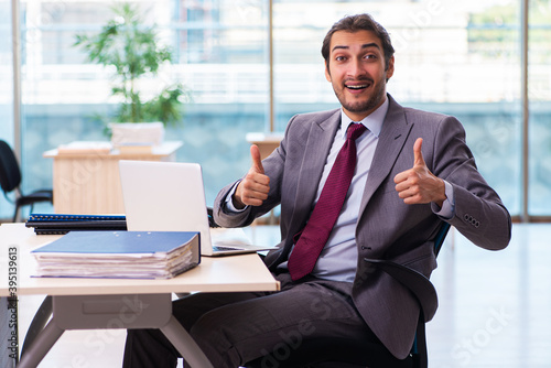 Young male employee working in the office