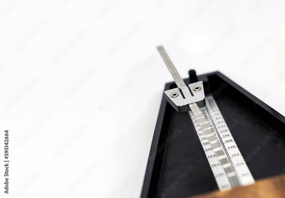 Detail of the pendulum of a classic metronome. Rhythm measurement tool. Detail of the pendulum of a classic metronome. Rhythm measurement tool.