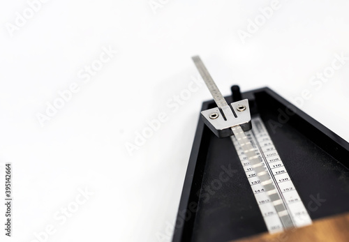 Detail of the pendulum of a classic metronome. Rhythm measurement tool.