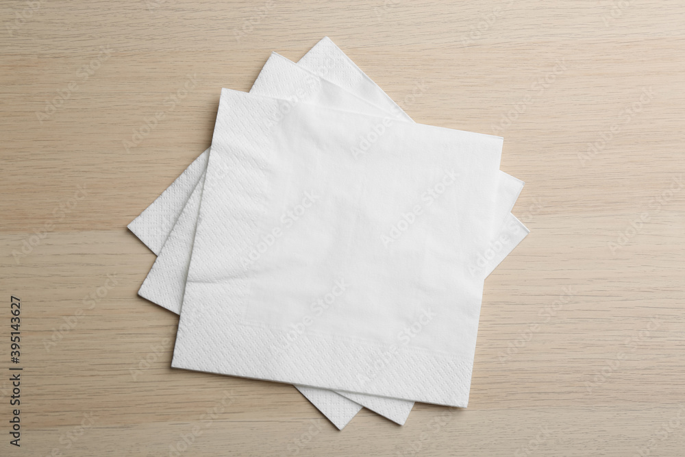 White clean paper tissues on wooden table, top view White clean paper tissues on wooden table, top view