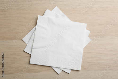 White clean paper tissues on wooden table, top view © New Africa
