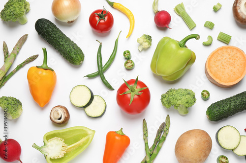 Flat lay composition with fresh vegetables on white background