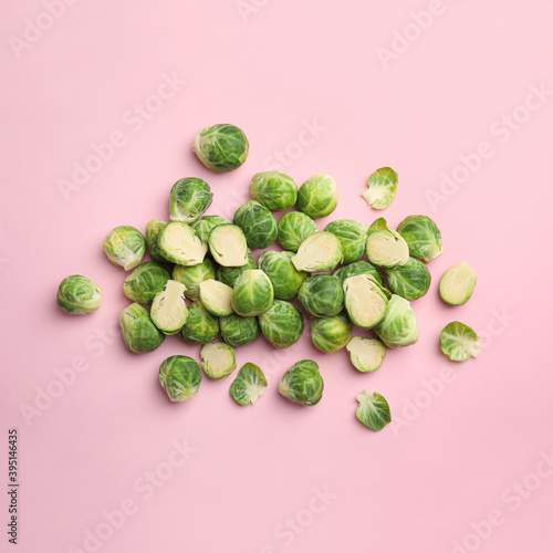 Fresh Brussels sprouts on pink background, flat lay