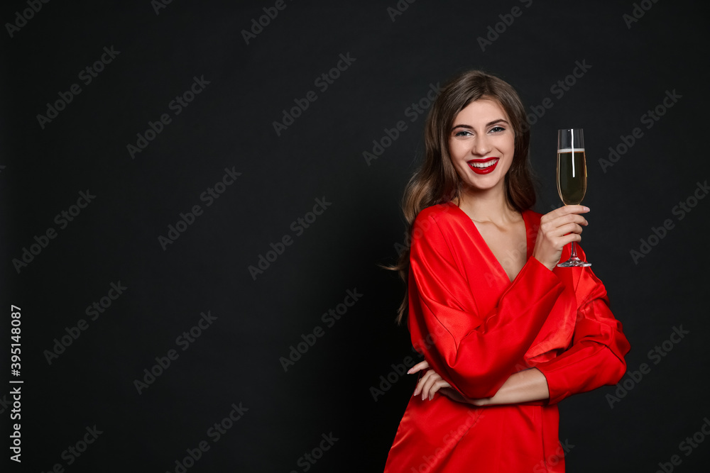 Happy woman with glass of champagne on black background, space for text. Christmas party Happy woman with glass of champagne on black background, space for text. Christmas party