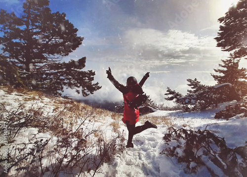Jumping woman at the winter landscape